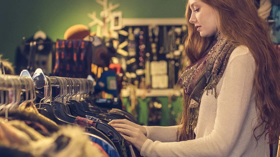 Woman browsing clothes on a rack in a shop